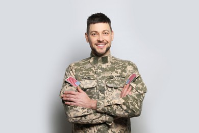 Photo of Portrait of happy cadet on light grey background