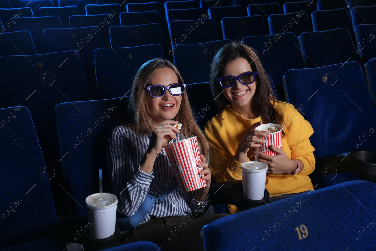 Photo of Young women watching movie in cinema theatre