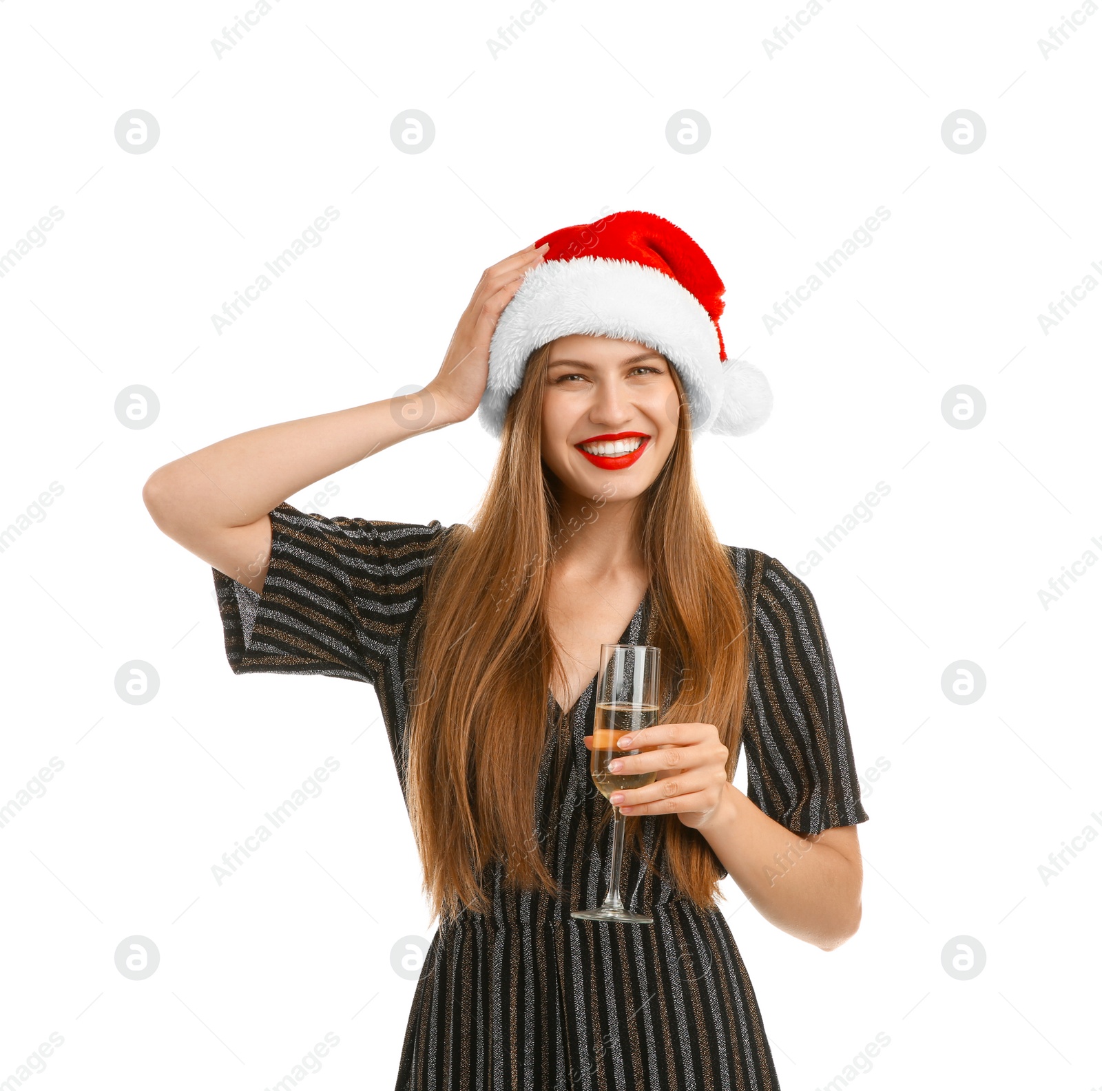 Photo of Young beautiful woman in Santa hat with glass of champagne on white background. Christmas celebration