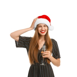 Photo of Young beautiful woman in Santa hat with glass of champagne on white background. Christmas celebration