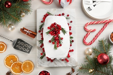 Photo of Flat lay composition with traditional classic Christmas cake on light table