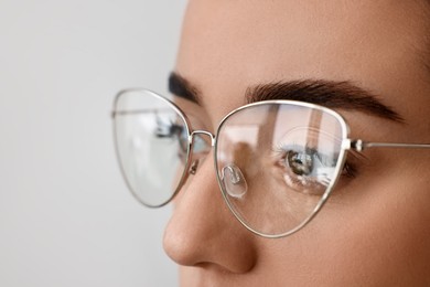 Woman wearing glasses on blurred background, closeup