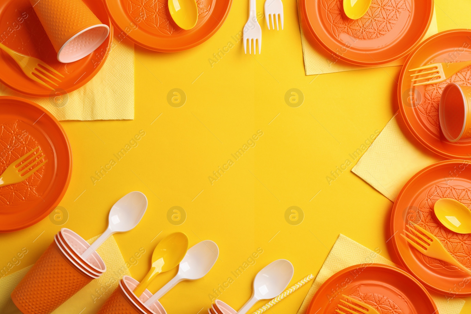 Photo of New plastic dishware and space for text on color background. Table setting