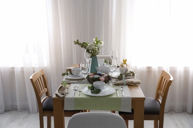 Photo of Beautiful Easter table setting with festive decor indoors