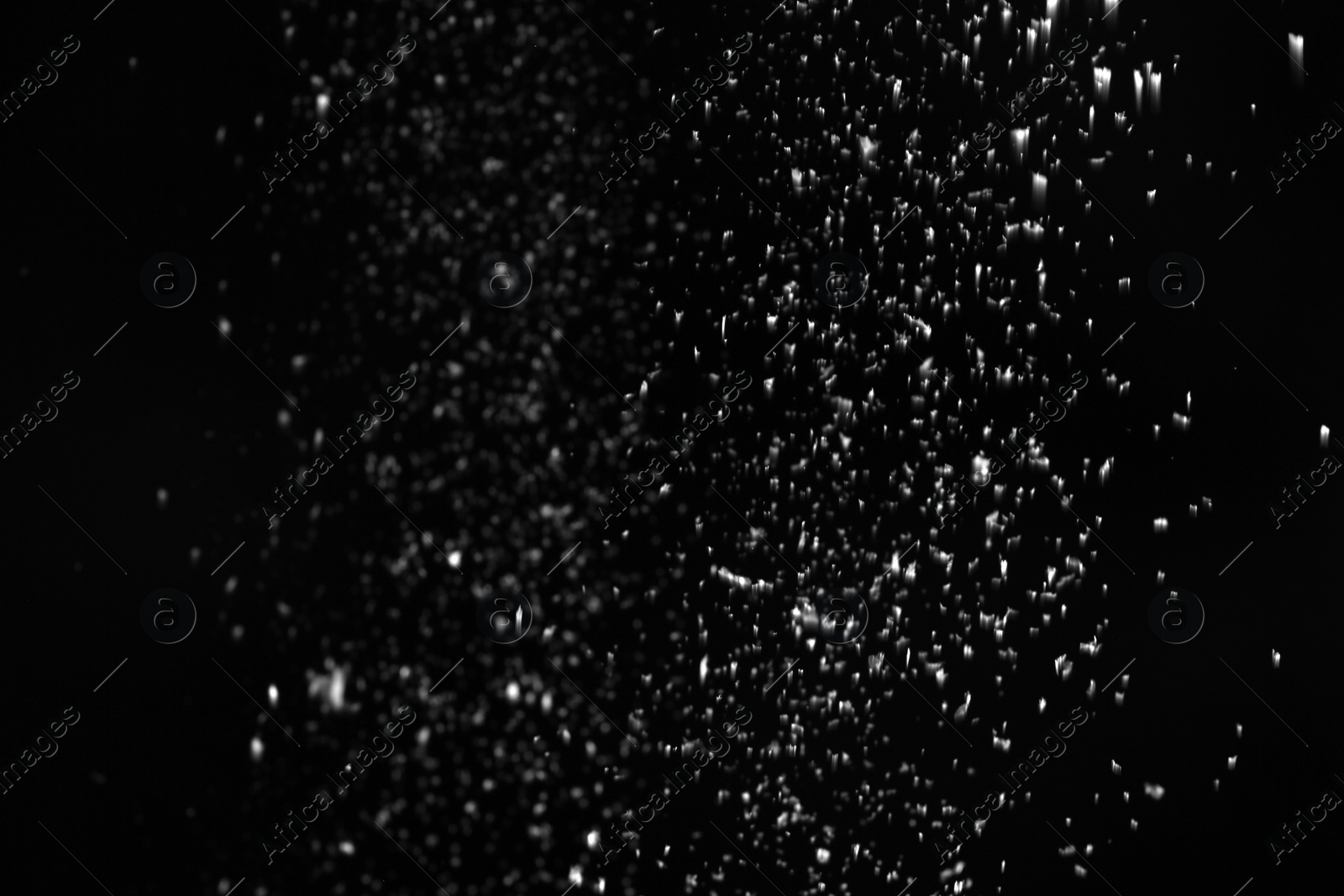 Photo of Snow flakes falling on black background. Winter weather