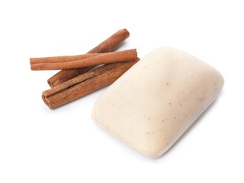Photo of Soap bar and cinnamon sticks on white background