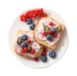 Tasty sandwiches with cream cheese, blueberries and red currants isolated on white, top view