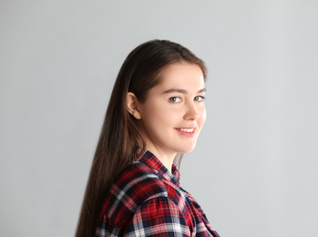 Photo of Portrait of young woman on light background