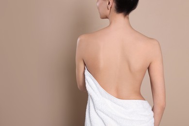 Photo of Back view of woman with perfect smooth skin on beige background, space for text