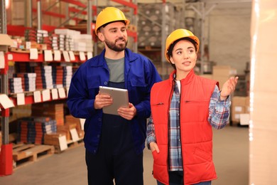 Image of Manager and worker at warehouse. Logistics center