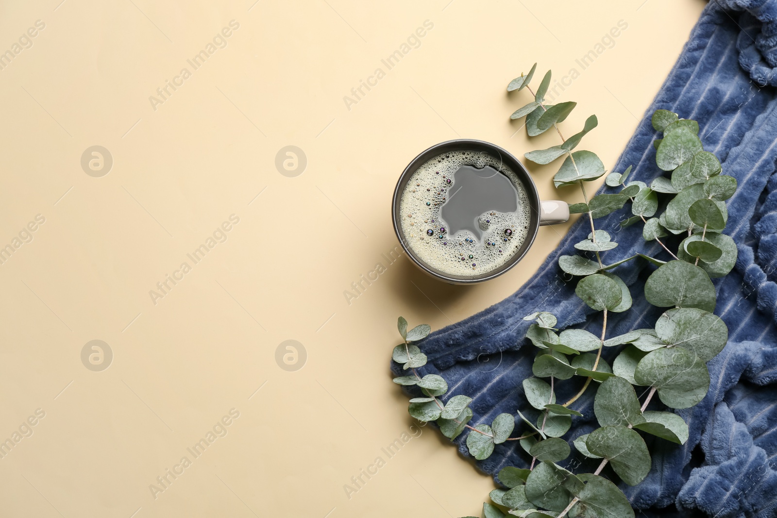 Photo of Flat lay composition with hot drink and warm plaid on beige background, space for text