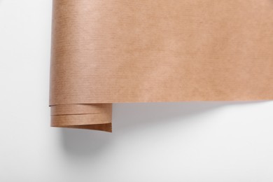 Photo of Roll of wrapping paper on white background, top view