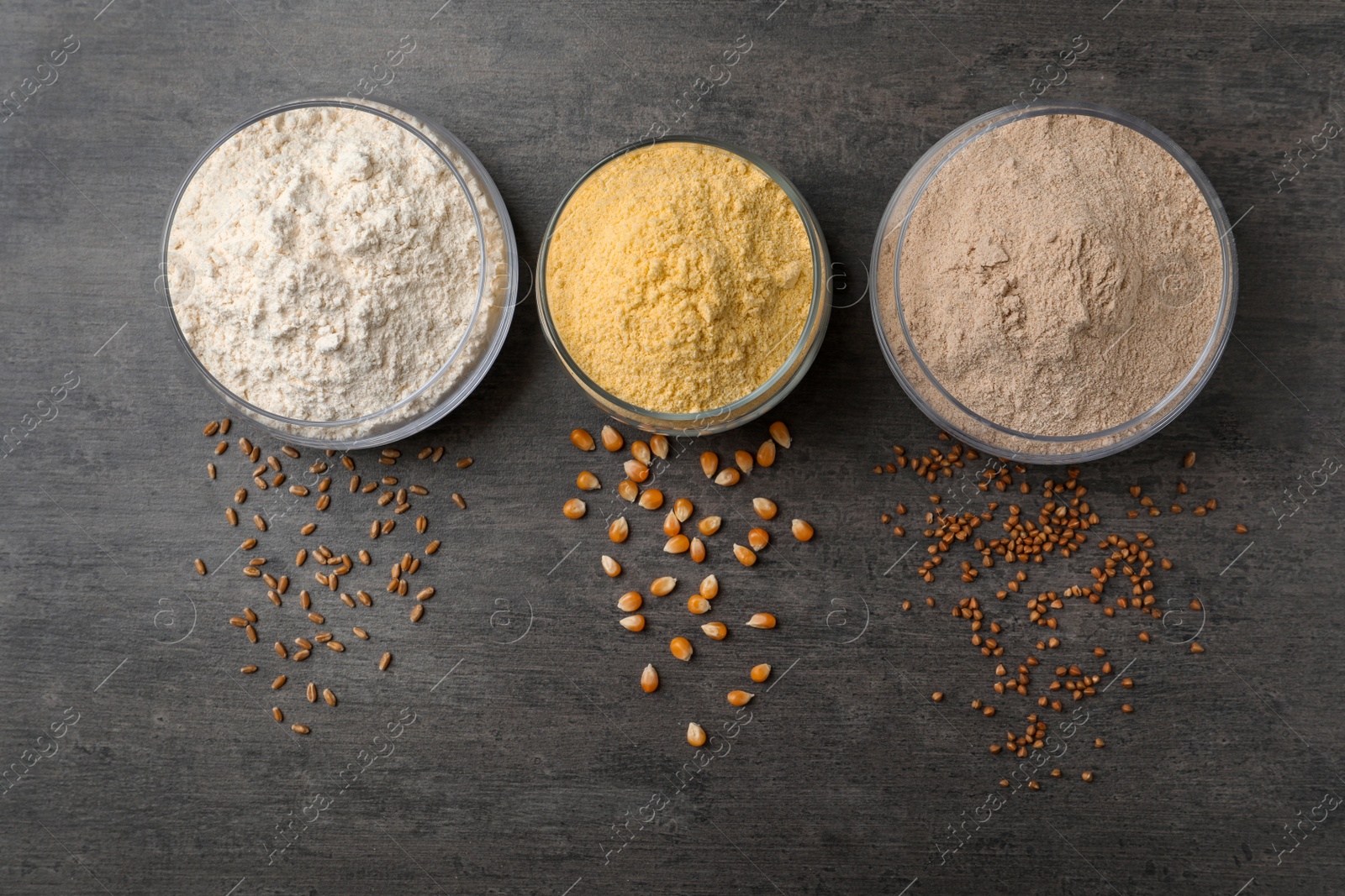 Photo of Jars with different types of flour on gray background