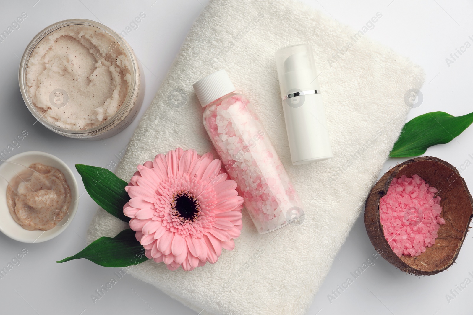 Photo of Flat lay composition with different spa products and beautiful flower on white table