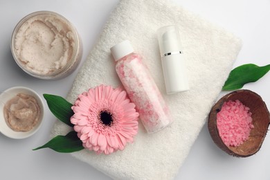 Flat lay composition with different spa products and beautiful flower on white table