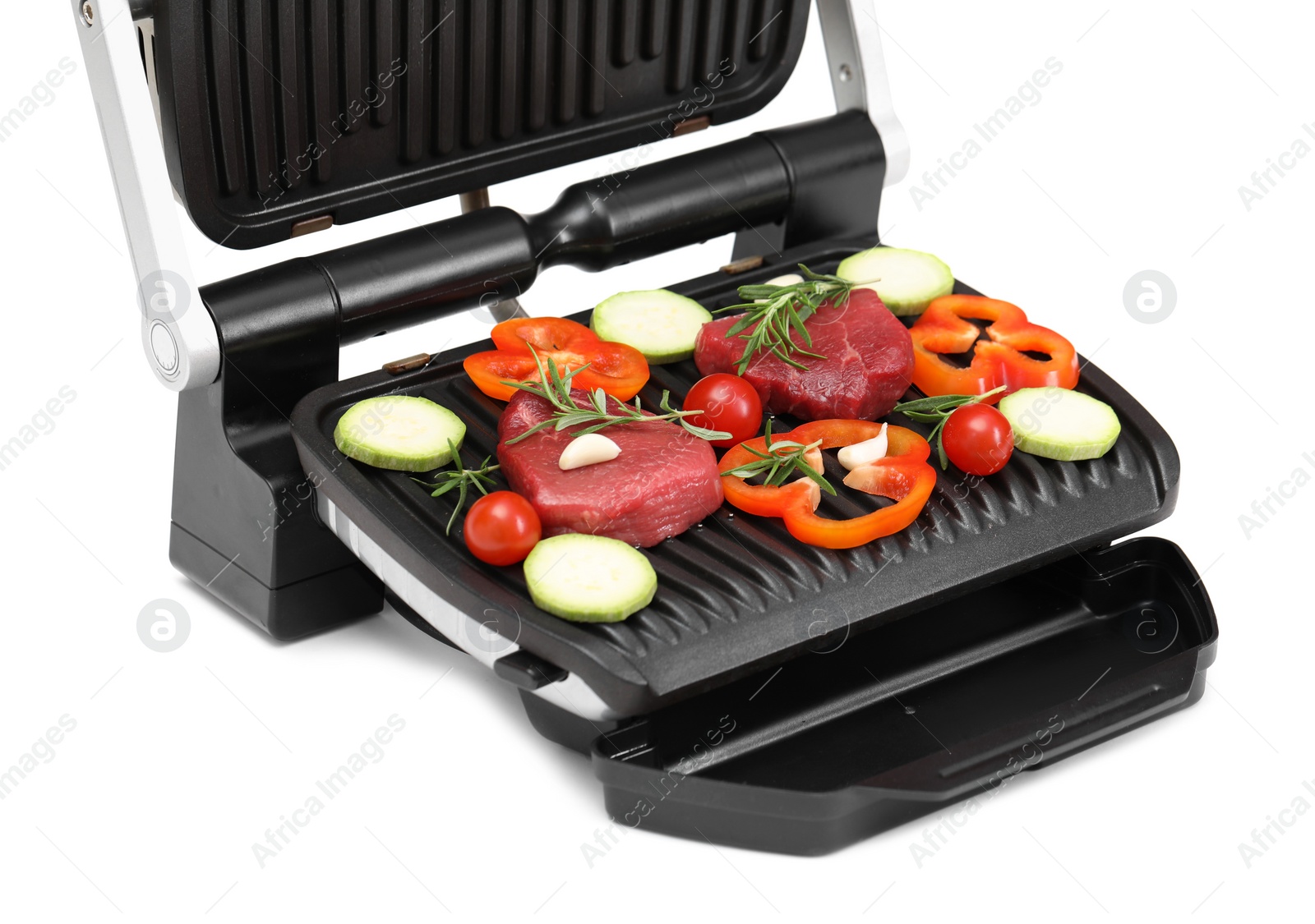 Photo of Electric grill with raw meat, rosemary and vegetables isolated on white