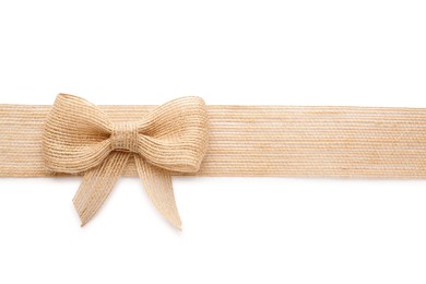 Burlap ribbon with pretty bow on white background, top view