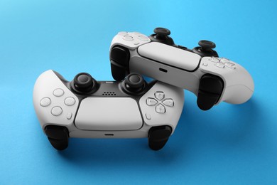 Photo of Wireless game controllers on light blue background