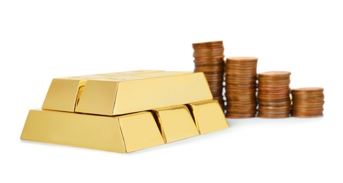 Photo of Shiny gold bars and coins on white background