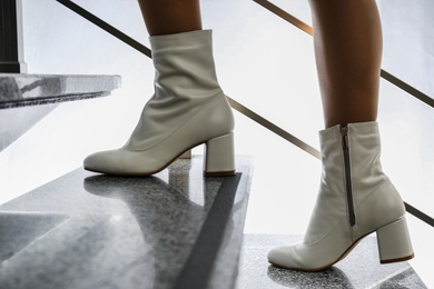 Photo of Woman wearing stylish leather shoes on stairs, closeup