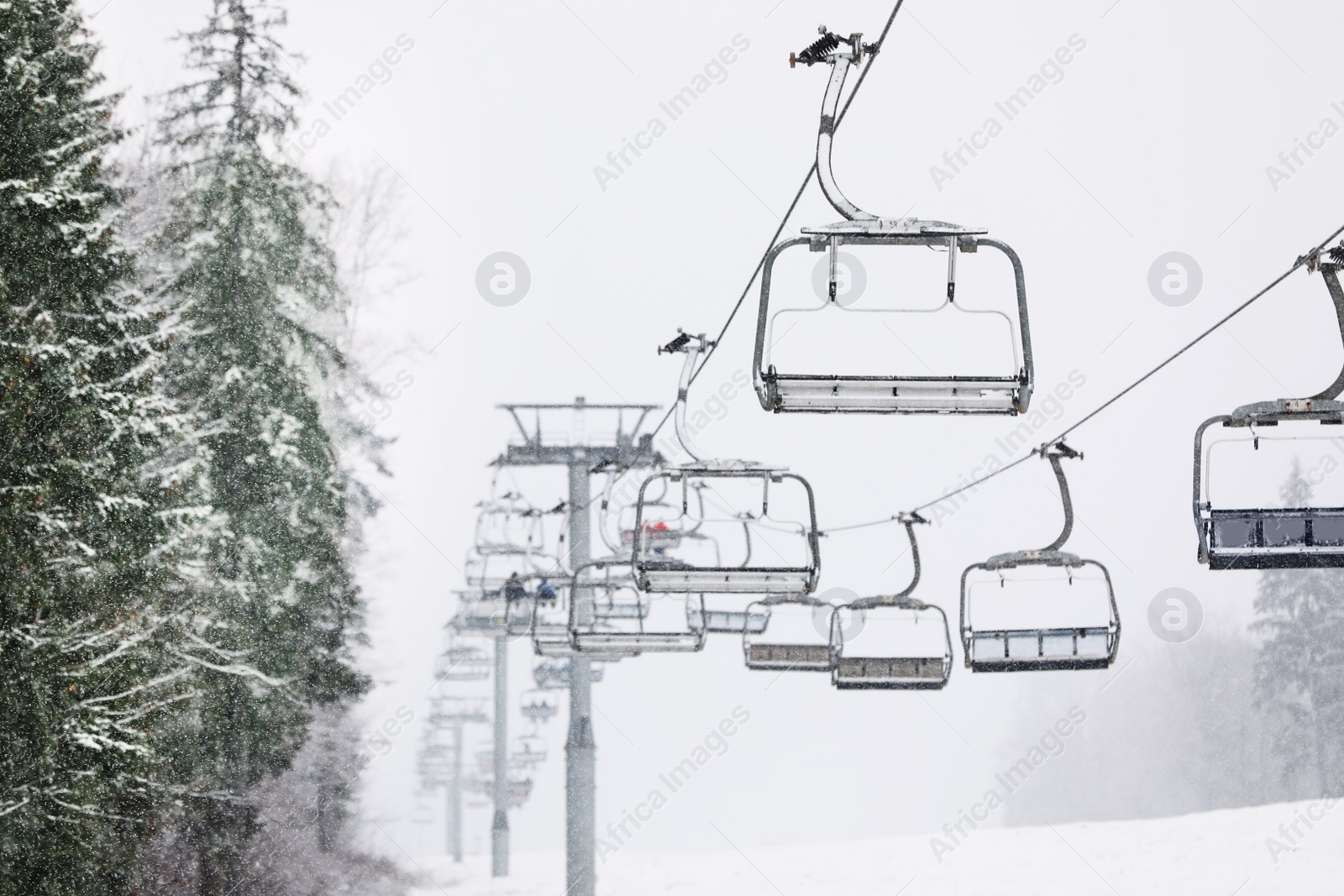 Photo of Ski lift at mountain resort. Winter vacation