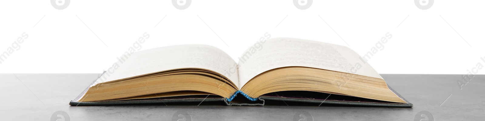 Photo of Open old hardcover book on grey table