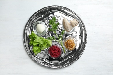 Photo of Traditional silver plate with symbolic meal for Passover (Pesach) Seder on wooden background, top view