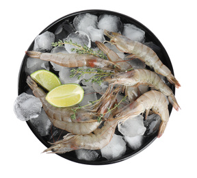 Plate with raw shrimps, lime slices, thyme and ice isolated on white, top view
