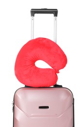 Photo of Red travel pillow on suitcase against white background