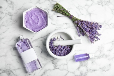 Photo of Flat lay composition with lavender flowers and natural cosmetic on marble background