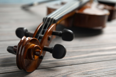 Photo of Classic violin on wooden background, closeup view