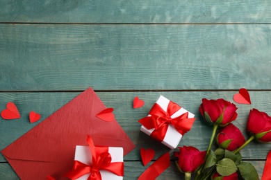 Photo of Flat lay composition with gift boxes on wooden table, space for text. Valentine's Day celebration