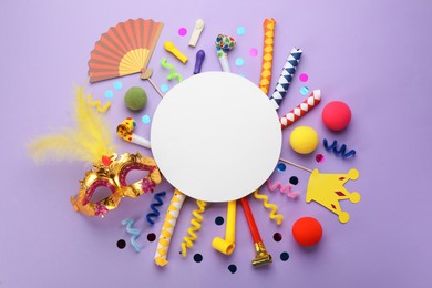 Flat lay composition with carnival items and blank card on violet background. Space for text