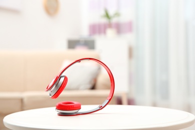 Photo of Stylish headphones on table indoors. Space for text