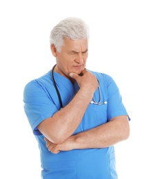 Photo of Portrait of pensive male doctor in scrubs with stethoscope isolated on white. Medical staff