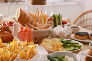 Photo of Dishes with different food on table in room. Luxury brunch