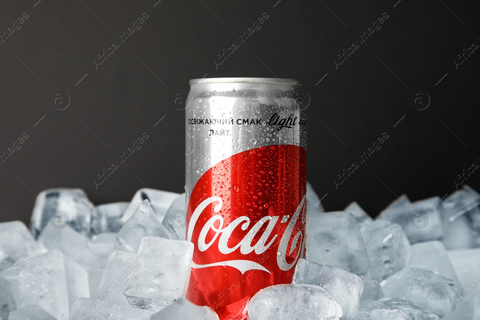 Photo of MYKOLAIV, UKRAINE - NOVEMBER 15, 2018: Coca Cola can on ice cubes against black background