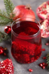 Aromatic Sangria cocktail in glass on grey table, closeup. Christmas drink