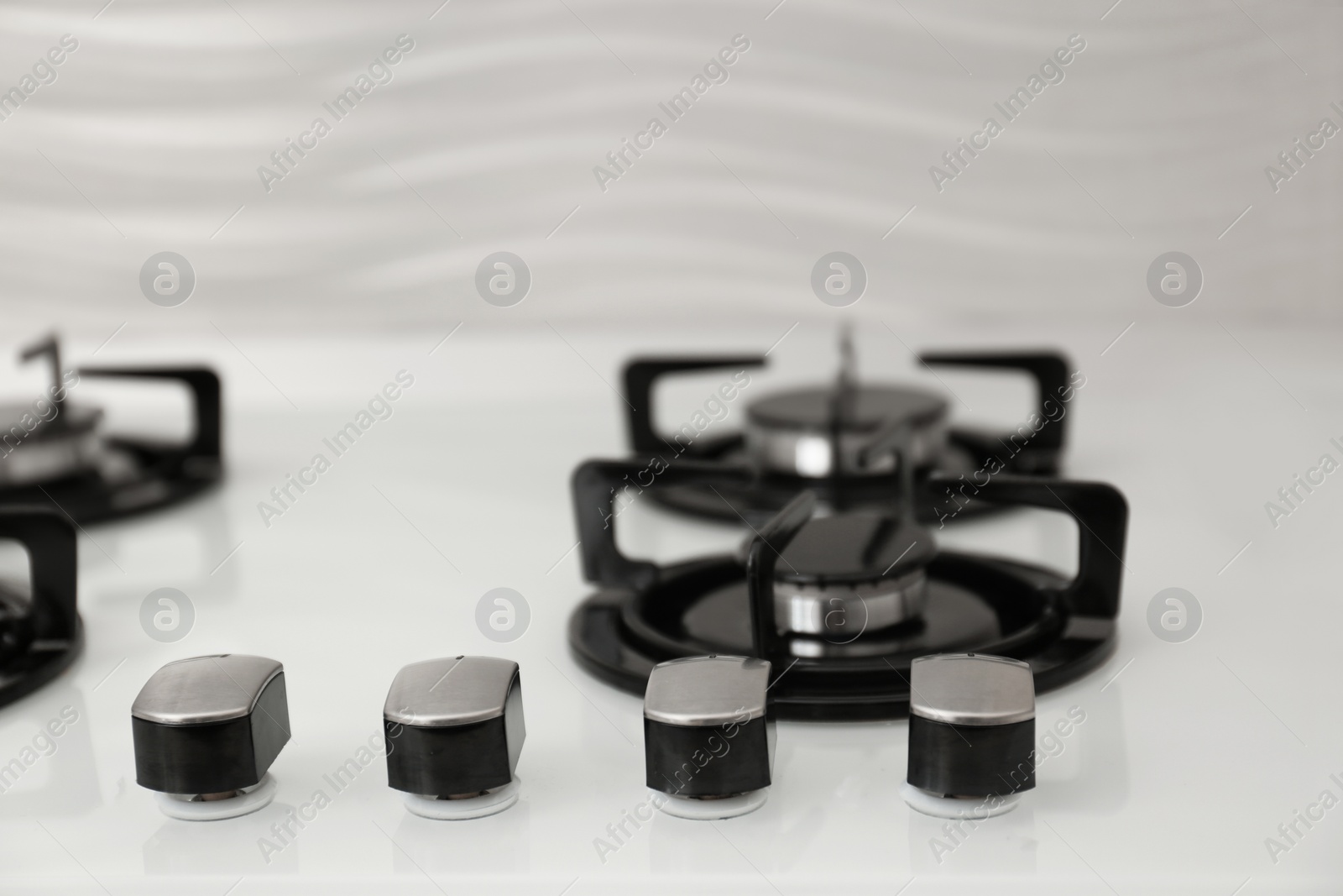 Photo of Modern built-in gas cooktop, closeup. Kitchen appliance