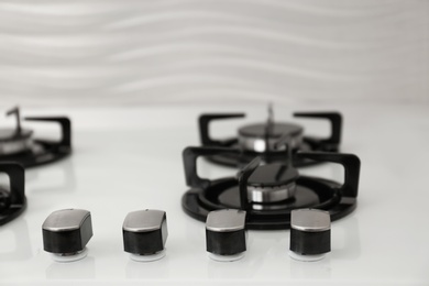 Photo of Modern built-in gas cooktop, closeup. Kitchen appliance