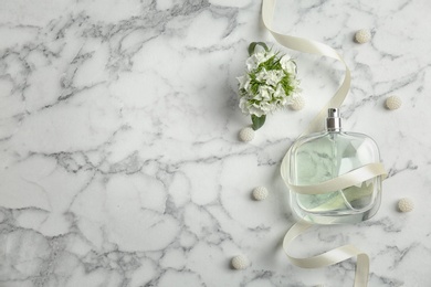 Photo of Beautiful composition with bottle of perfume on light background, flat lay