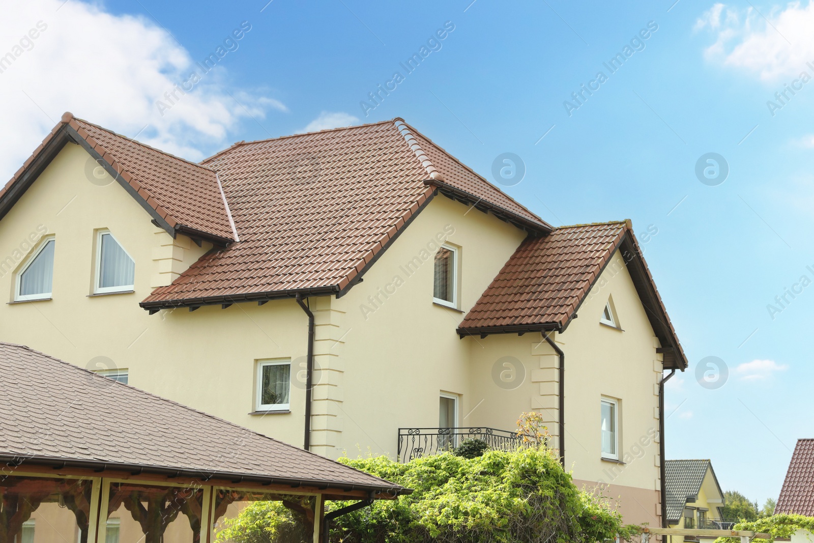 Photo of Modern building with brown roof outdoors on sunny day