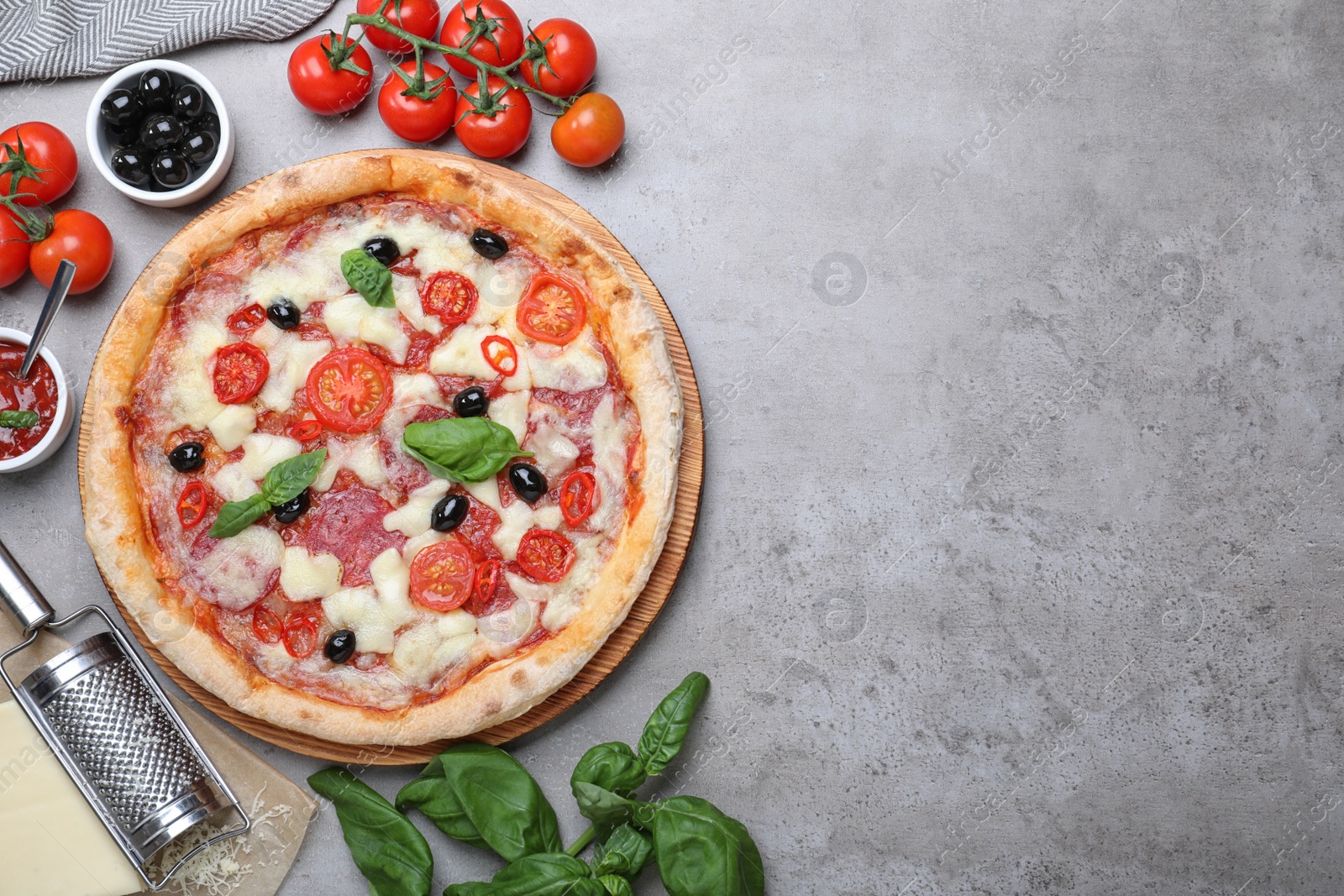 Photo of Delicious pizza Diablo on grey table, flat lay. Space for text