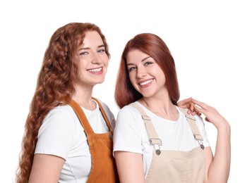 Portrait of beautiful young redhead sisters on white background