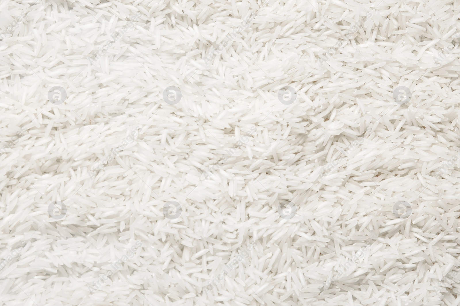 Photo of Raw basmati rice as background, top view