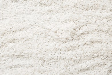 Photo of Raw basmati rice as background, top view