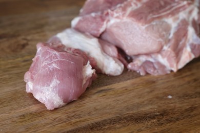 Photo of Fresh raw meat on wooden board, closeup. Space for text
