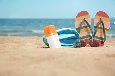 Photo of Set of different beach objects on sand near sea. Space for text
