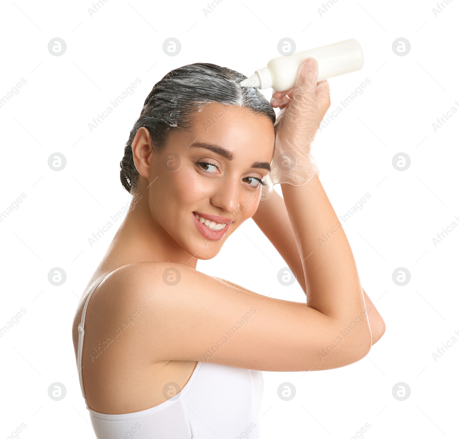 Photo of Young woman dyeing her hair against white background