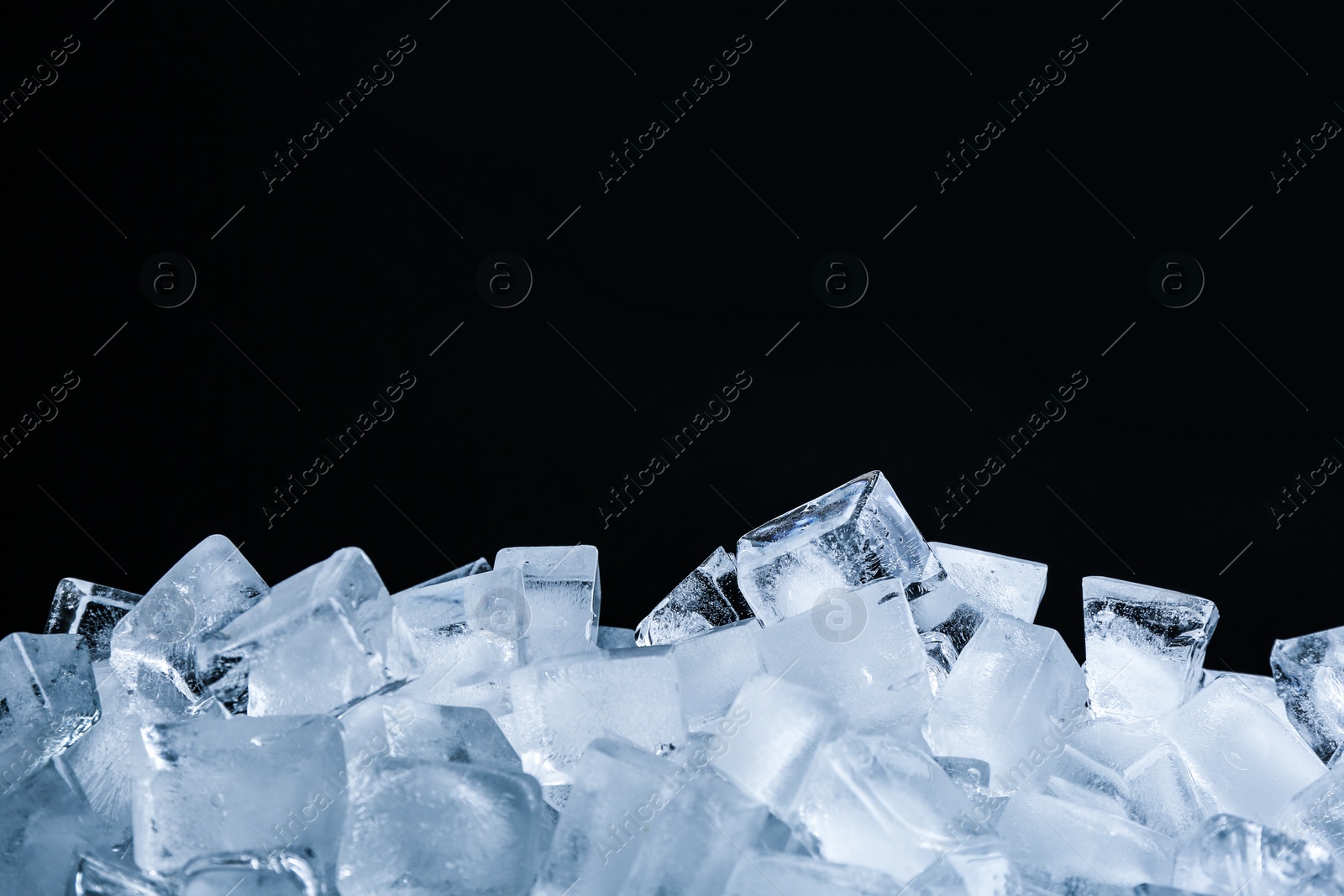 Photo of Ice cubes on black background, closeup view